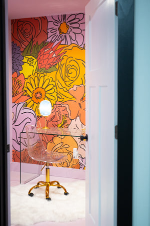 Doorway leading into a room with bright flowers on the walls