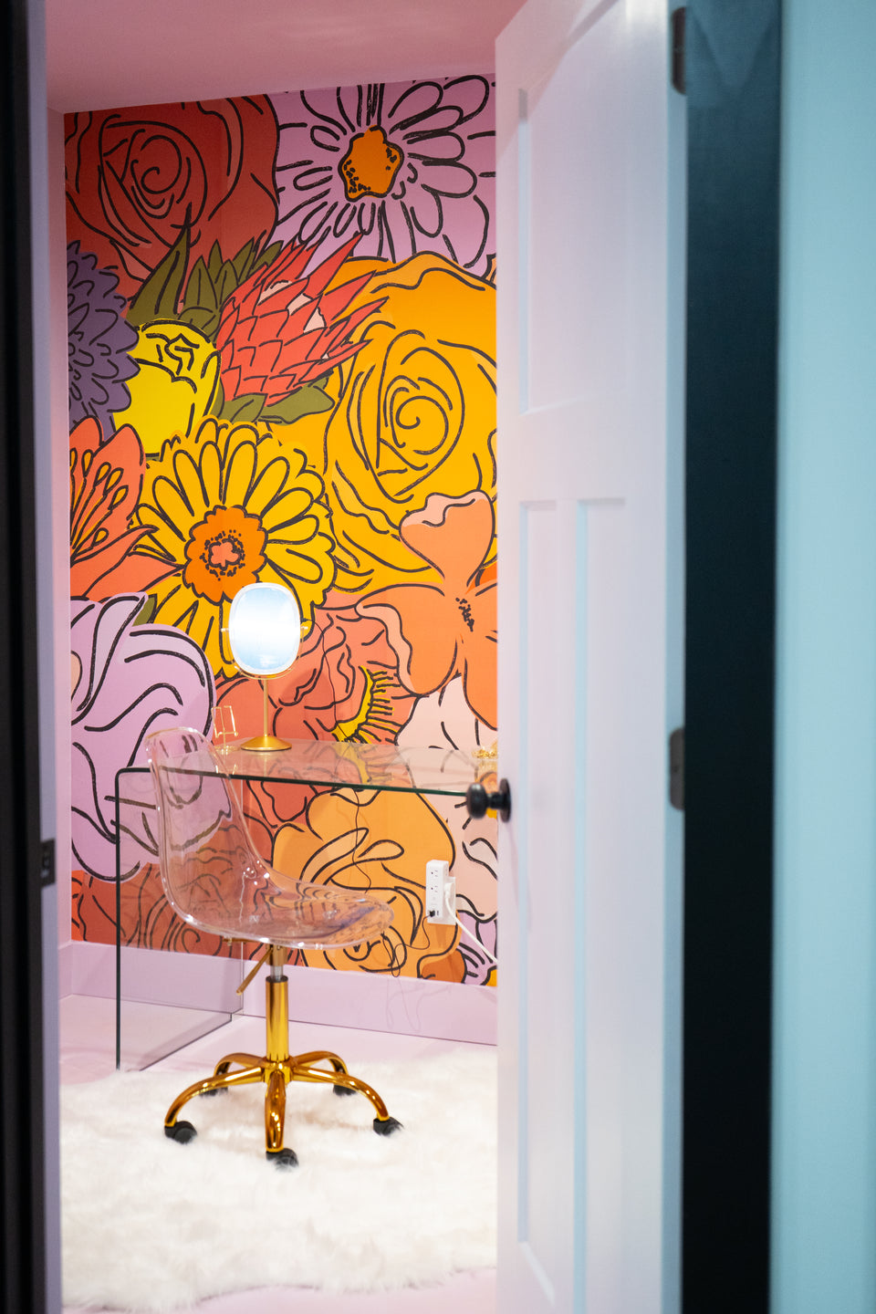 Doorway leading into a room with bright flowers on the walls