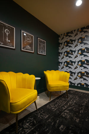 Bright yellow chairs on a dark wall