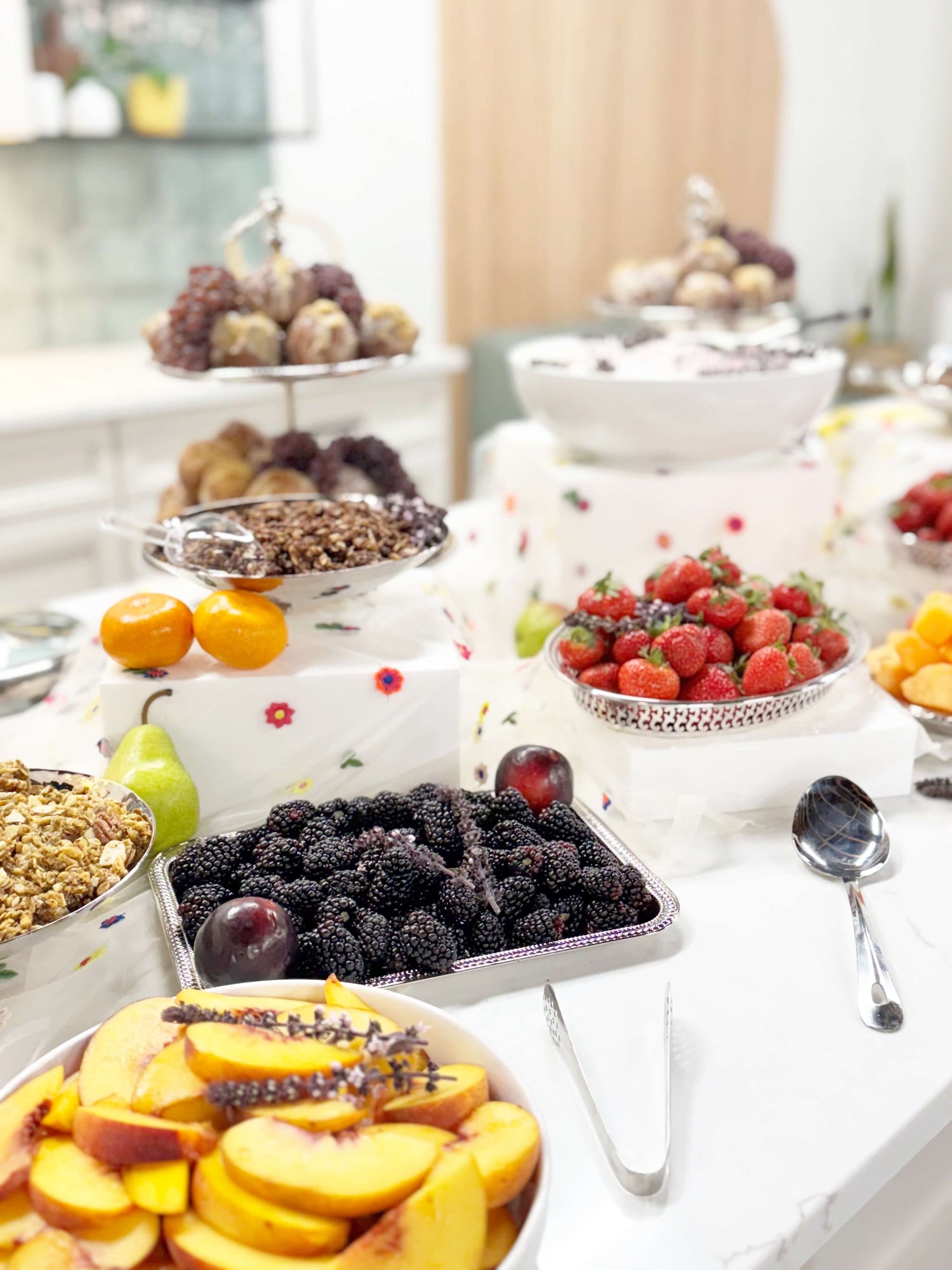 Fruit and dessert display on a table with various fruits and pastries.